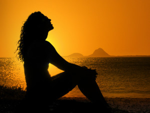 woman worshipping at sunset