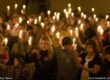 Worshippers celebrating Christmas with candles