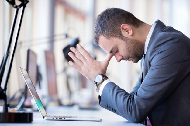 man at computer praying about giving