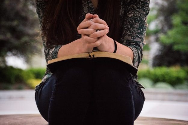 woman in prayer with her bible